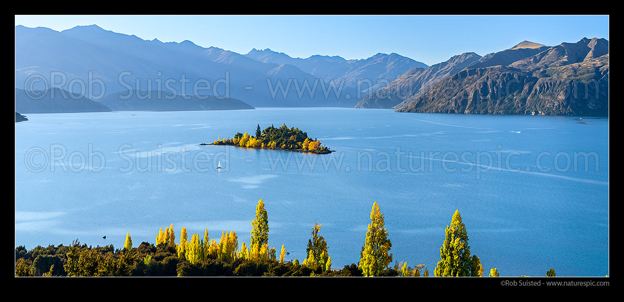 Image of Lake Wanaka in autumn colours, with small boats enjoying a fine autumn day. Panorama, Wanaka, Queenstown Lakes District, Otago Region, New Zealand (NZ) stock photo image