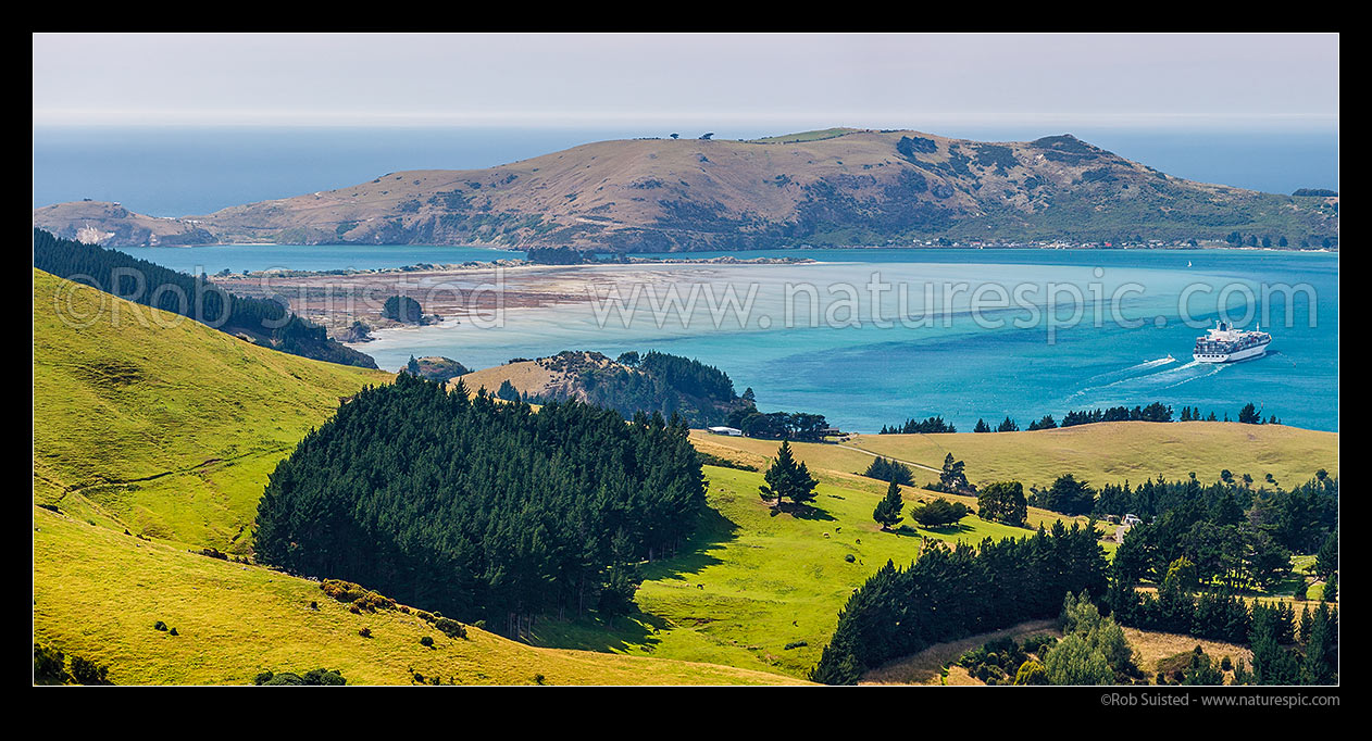 Image of Otago Harbour entrance. Aramoana Beach, The Spit and Taiaroa Head at left. Container ship in channel far right, Port Chalmers, Dunedin City District, Otago Region, New Zealand (NZ) stock photo image