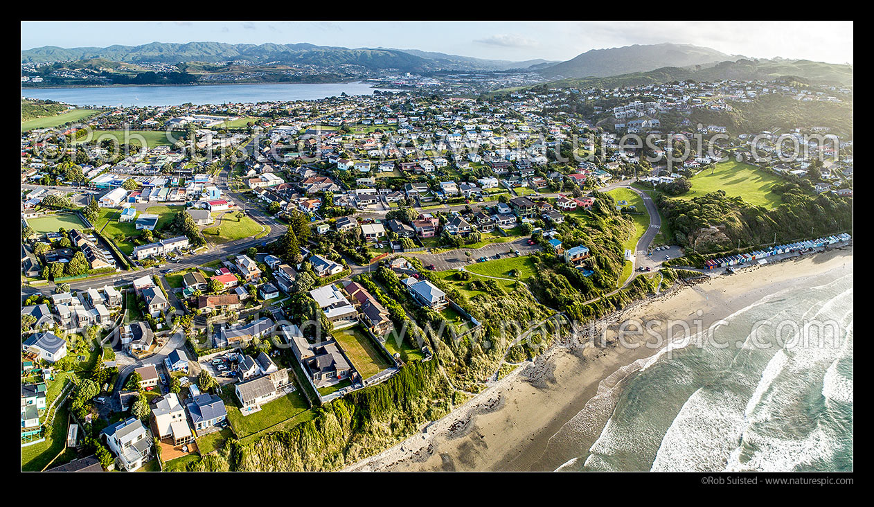 Image of Titahi Bay beach and suburb, with Porirua Harbour behind. Looking south towards Porirua and Colonial Knob (468m) at right. Panorama, Titahi Bay, Porirua City District, Wellington Region, New Zealand (NZ) stock photo image