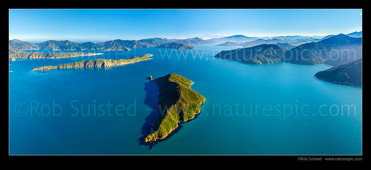 Image of Motuara Island in Outer Queen Charlotte Sound (Totaranui), with Long Island (Kokomohua) and Arapawa at left. Ship Cove far right, Kaikoura Ranges distant. Aerial panorama, Marlborough Sounds, Marlborough District, Marlborough Region, New Zealand (NZ) stock photo image