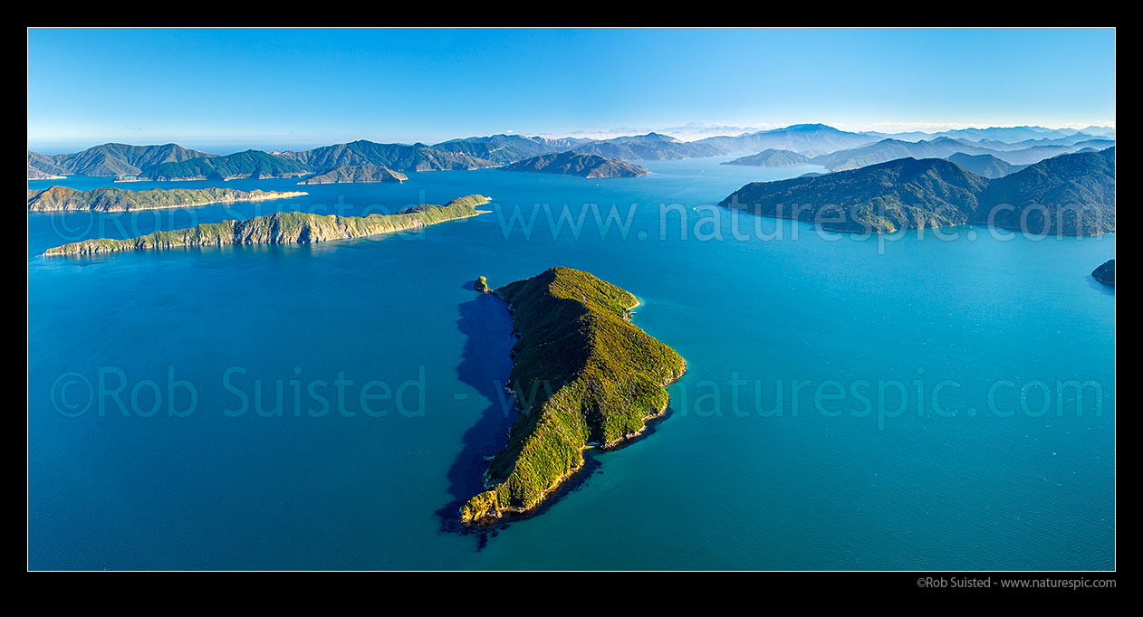 Image of Outer Queen Charlotte Sound (Totaranui) and Motuara Island (centre), with Long Island (Kokomohua) and Arapawa at left. Ship Cove far right, Kaikoura Ranges distant. Aerial panorama, Marlborough Sounds, Marlborough District, Marlborough Region, New Zealand (NZ) stock photo image