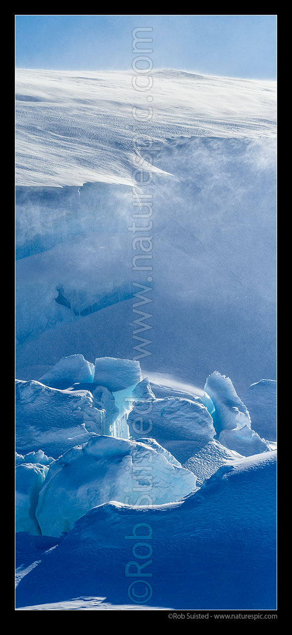 Image of Catabatic blizzard winds blow spindrift, snow and ice particles over the ice sheet and and pressure ridges below. Vertical panorama, Ross Sea, Antarctica Region, Antarctica stock photo image