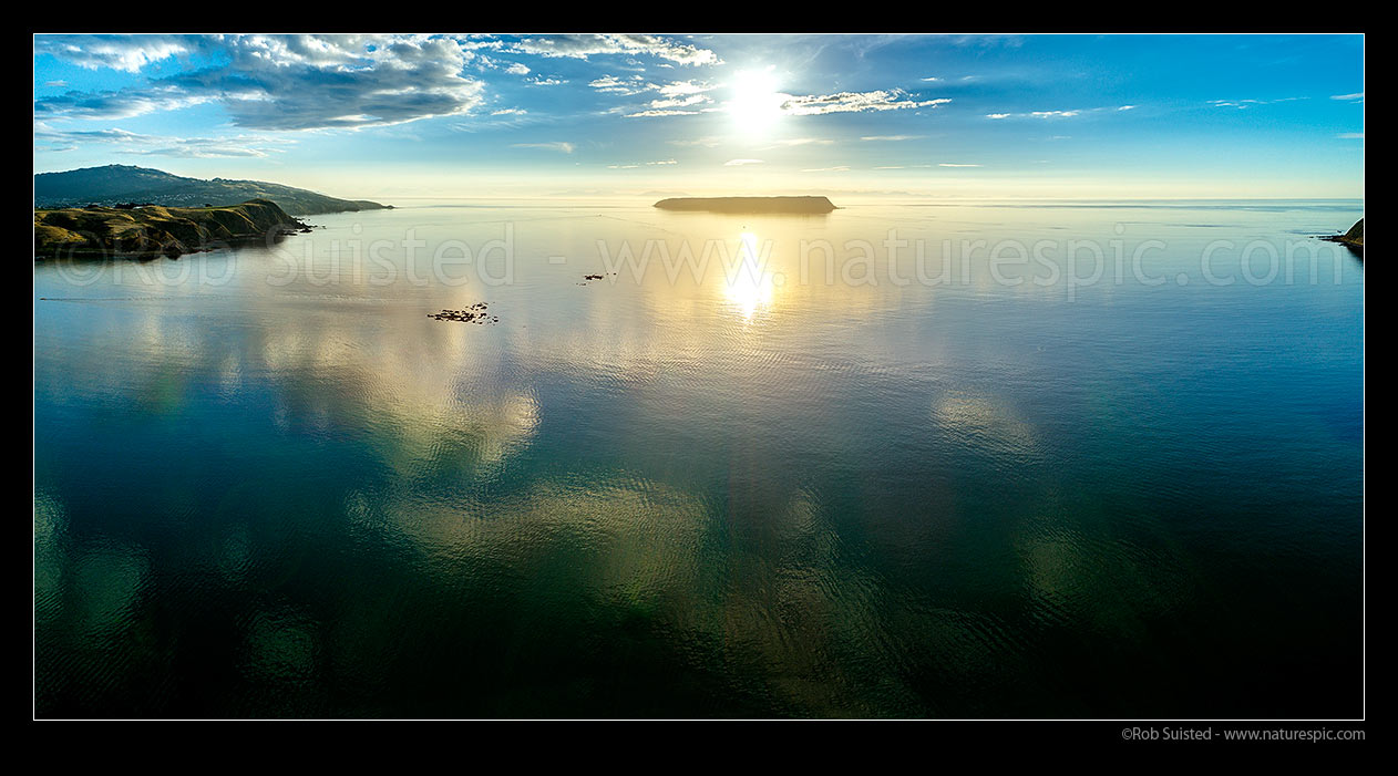 Image of Mana Island offshore of Plimmerton Beach. Grandfather Rocks (Tokaapapa Reef) and Titahi Bay Whitireia Park at left. Aerial panorama, Plimmerton, Porirua City District, Wellington Region, New Zealand (NZ) stock photo image