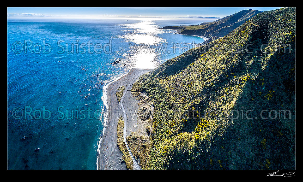 Image of Wellington South Coast. Tongue Point and Karori Rock light, with South Island beyond over Cook Strait. West Wind turbine farm at right. Aerial panorama, Wellington South Coast, Wellington City District, Wellington Region, New Zealand (NZ) stock photo image