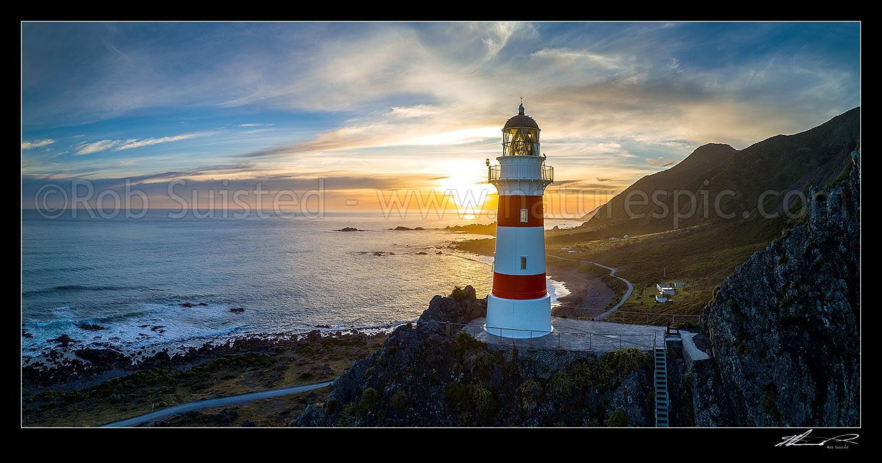 Image of Cape Palliser lighthouse looking out over Palliser Bay at sunset. Aerial panorama, Cape Palliser, South Wairarapa District, Wellington Region, New Zealand (NZ) stock photo image