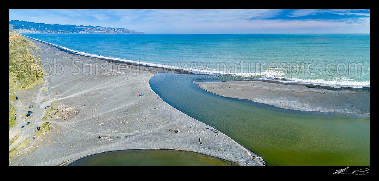 Image of Lake Ferry (Onoke) outlet draining the Ruamahanga River into Palliser Bay. Whangaimoana Beach and Cape Palliser at left. Aerial panorama, Lake Ferry, South Wairarapa District, Wellington Region, New Zealand (NZ) stock photo image