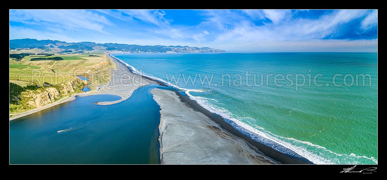 Image of Lake Ferry (Onoke) and outlet into Palliser Bay. Looking along Whangaimoana Beach towards the Aorangi Ranges behind. Cape Palliser centre distance. Aerial panorama, Lake Ferry, South Wairarapa District, Wellington Region, New Zealand (NZ) stock photo image