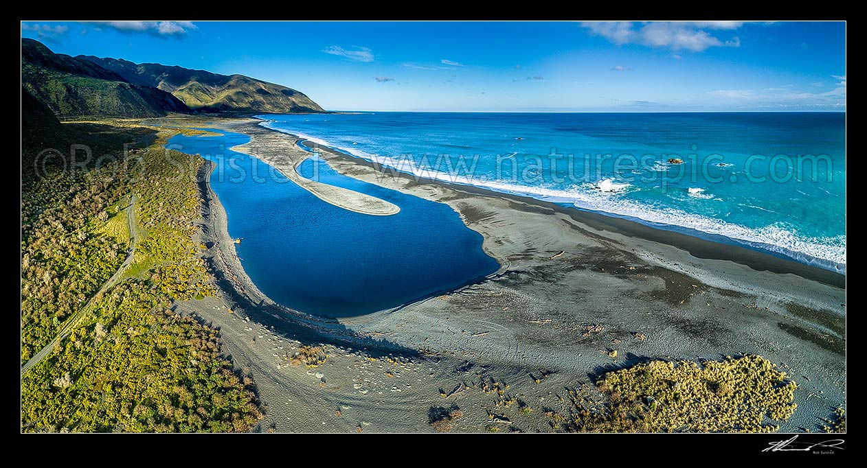 Image of Wainuiomata River mouth entering sea near Baring Head, forms a coastal tidal lake as it snakes through beach gravels. Aerial panorama view. Turakirae head behind, Baring Head, Hutt City District, Wellington Region, New Zealand (NZ) stock photo image