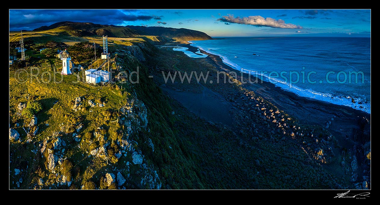 Image of Baring Head lighthouse and buildings high above coast at Baring Head. Wainuiomata River mouth and Cape Turakirae beyond. Aerial panorama at dusk, Baring Head, Hutt City District, Wellington Region, New Zealand (NZ) stock photo image