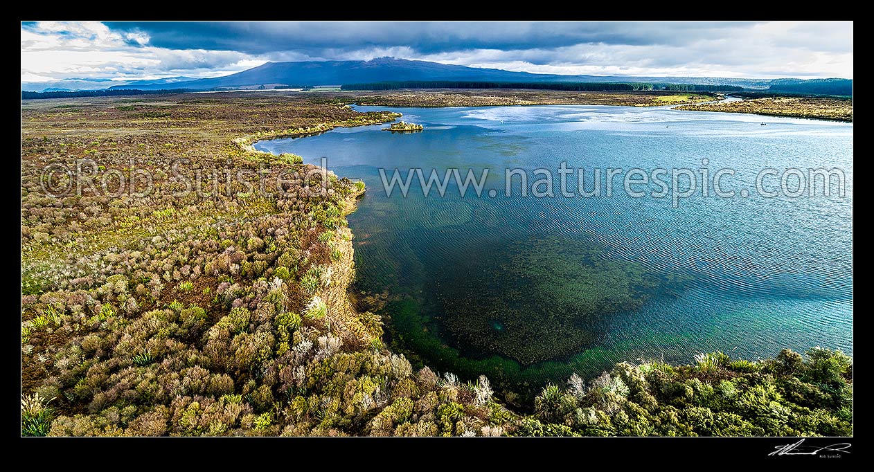 Image of Lake Otamangakau aerial panorama. Mt Tongariro in cloud beyond, and Otamangakau canal at right, Tongariro, Ruapehu District, Manawatu-Wanganui Region, New Zealand (NZ) stock photo image