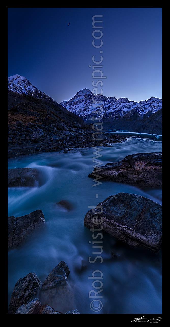 Image of Aoraki / Mount Cook (3754m) above the rushing Hooker River. Pre-dawn colours, with moon high above. Vertical panorama, Aoraki / Mount Cook National Park, MacKenzie District, Canterbury Region, New Zealand (NZ) stock photo image