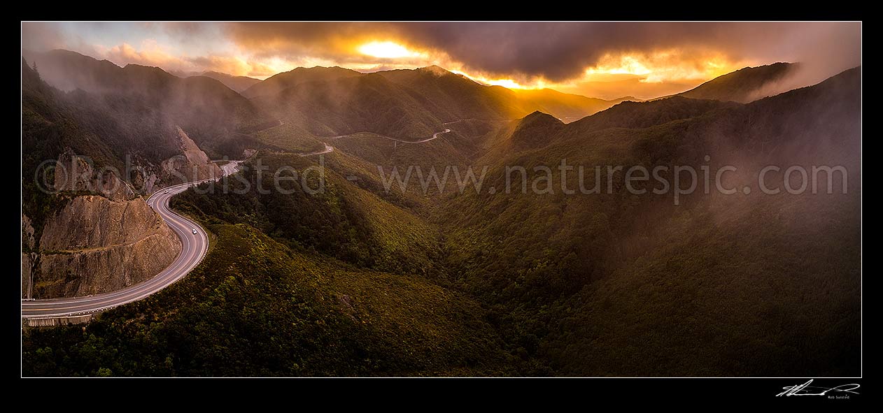 Image of Remutaka (Rimutaka) Hill Road (State Highway 2, SH2) climbing over the Remutaka (Rimutaka) Ranges summit (555m) from Upper Hutt to the Wairarapa. Aerial panorama on a moody evening, Remutaka, Upper Hutt City District, Wellington Region, New Zealand (NZ) stock photo image