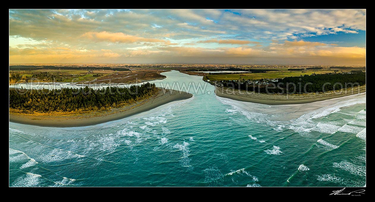 Image of Waimakariri River mouth at sunrise. Brooklands Lagoon at left, Kairaki and The Pines Beach at right, Canterbury plains beyond. Aerial panorama, Kaiapoi, Waimakariri District, Canterbury Region, New Zealand (NZ) stock photo image