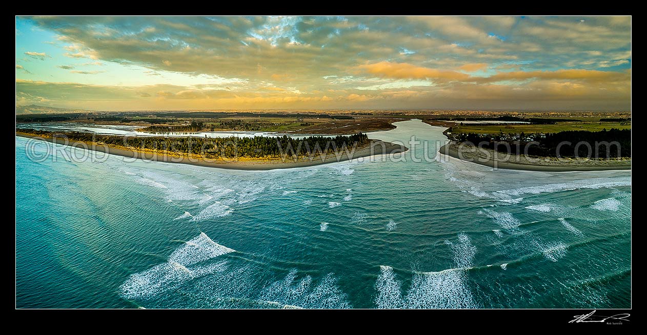 Image of Waimakariri River mouth at sunrise. Brooklands Lagoon at left, Kairaki and The Pines Beach at right, Canterbury plains beyond. Aerial panorama, Kaiapoi, Waimakariri District, Canterbury Region, New Zealand (NZ) stock photo image