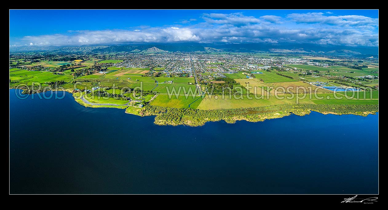 Image of Lake Horowhenua, seen from western shore. Levin towhship and Horowhenua plains beyond, with Tararua Ranges above. Aerial panorama view, Levin, Horowhenua District, Manawatu-Wanganui Region, New Zealand (NZ) stock photo image