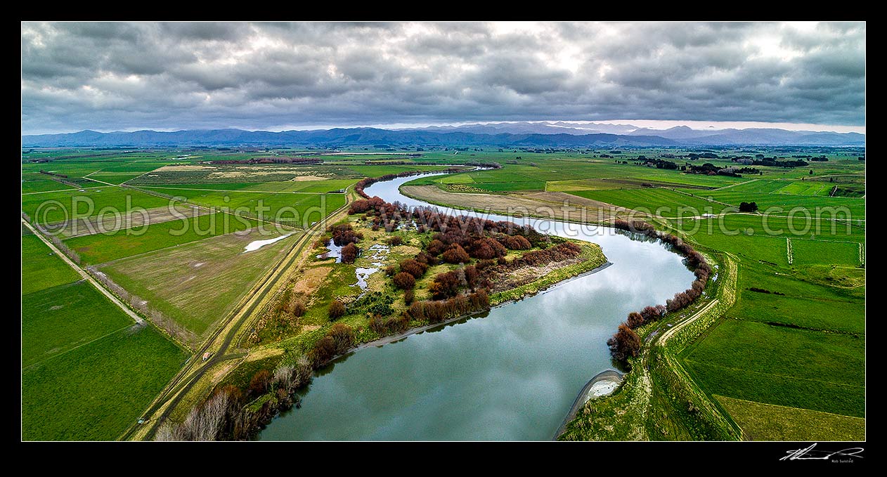 Image of Manawatu River winding in lower reaches on the Manawatu Plains. Moutoa Conservation Area and wetlands visible. Tararua Ranges beyond. Aerial panorama view, Koputaroa, Foxton, Horowhenua District, Manawatu-Wanganui Region, New Zealand (NZ) stock photo image