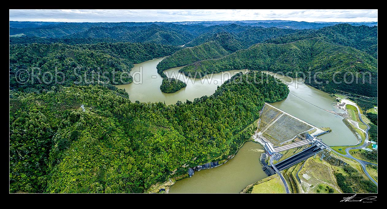 Image of Patea Dam on the Patea River, holding back Lake Rotorangi, a 46km long hydro power lake.  Patea Dam is rated at 31 MW output, 80m high, built 1984. Aerial panorama. Tarere Conservation Area, Patea, South Taranaki District, Taranaki Region, New Zealand (NZ) stock photo image