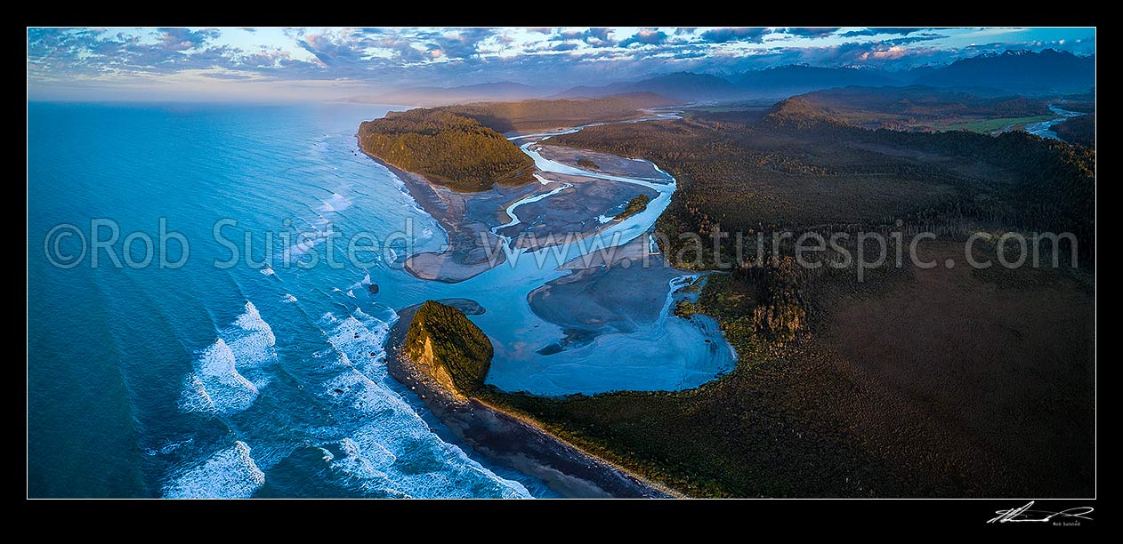 Image of Wanganui Heads, River mouth and tidal lagoon. Mt Oneone (56m) bottom centre, Wanganui Bluff above. Southern Alps beyond, and Poerua River far right. Moody aerial panorama at dusk, Harihari, Westland District, West Coast Region, New Zealand (NZ) stock photo image