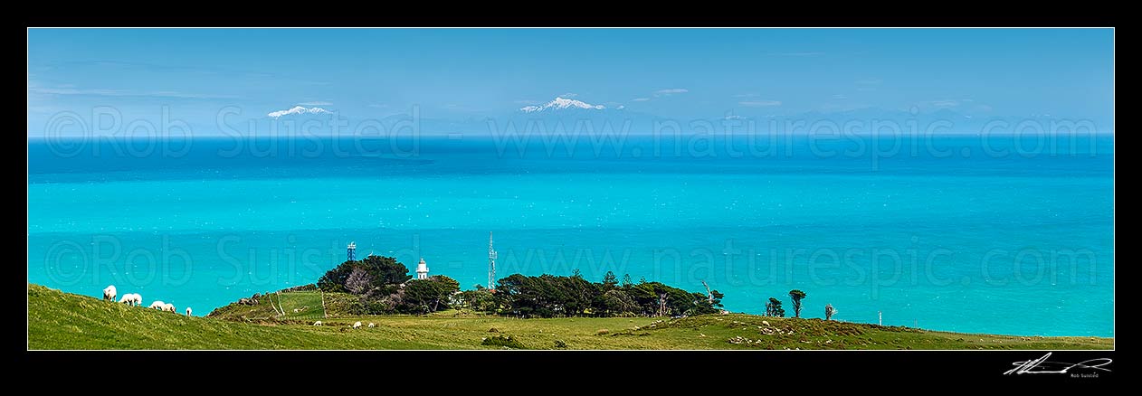 Image of Baring Head Lighthouse complex with Cook Strait, South Island and the Seaward Kaikoura Ranges and Inland Kaikoura Ranges beyond. East Harbour Regional Park. Panorama, Baring Head, Hutt City District, Wellington Region, New Zealand (NZ) stock photo image