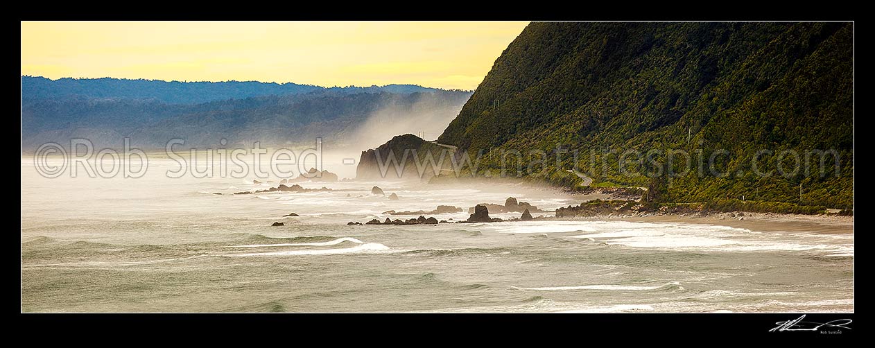 Image of Paparoa Coast Road (State Highway 6 SH6) passing Seventeen Mile Bluff as sea fog rolls in. Barrytown flats at left. Panorama, Barrytown, Grey District, West Coast Region, New Zealand (NZ) stock photo image