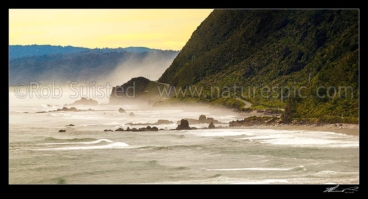 Image of Paparoa Coast Road (State Highway 6 SH6) passing Seventeen Mile Bluff as sea fog rolls in. Barrytown flats at left. Panorama, Barrytown, Grey District, West Coast Region, New Zealand (NZ) stock photo image