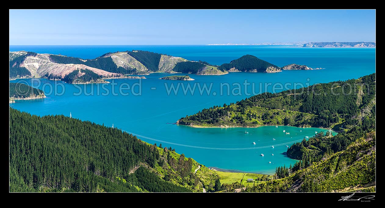 Image of Port Underwood. Oyster Bay and Willawa Point centre, with Horohora Kakayu Island and Robertson Point behind. White Bluffs, Cloudy Bay and Cape Campbell distant. Panorama, Port Underwood, Marlborough District, Marlborough Region, New Zealand (NZ) stock photo image