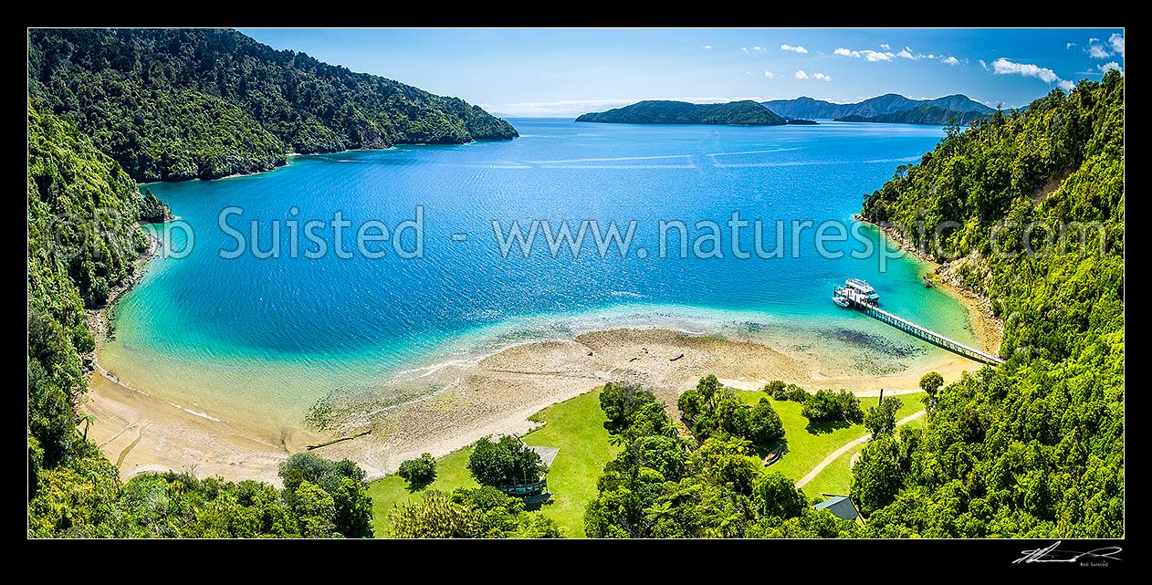 Image of Ship Cove (Meretoto) and Cook's Monument in the outer Queen Charlotte Sound (Totaranui). Start of the Queen Charlotte Walking Track. Motuara Island beyond. Aerial panorama, Marlborough Sounds, Marlborough District, Marlborough Region, New Zealand (NZ) stock photo image