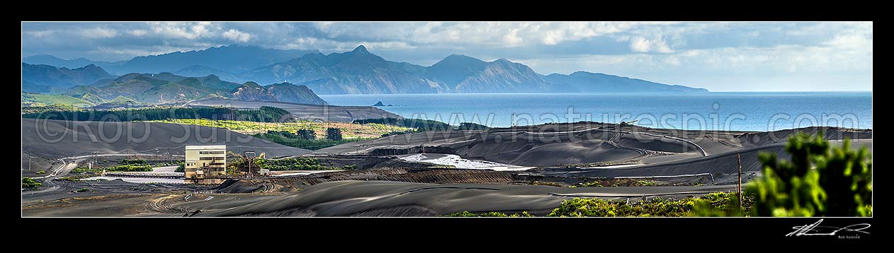 Image of Taharoa Ironsand mine operation owned by NZ Steel, mining iron rich ironsands. Panorama view with steep peak of Mt Whareorino (649m) behind. Tirua Point far right, Taharoa, Waitomo District, Waikato Region, New Zealand (NZ) stock photo image