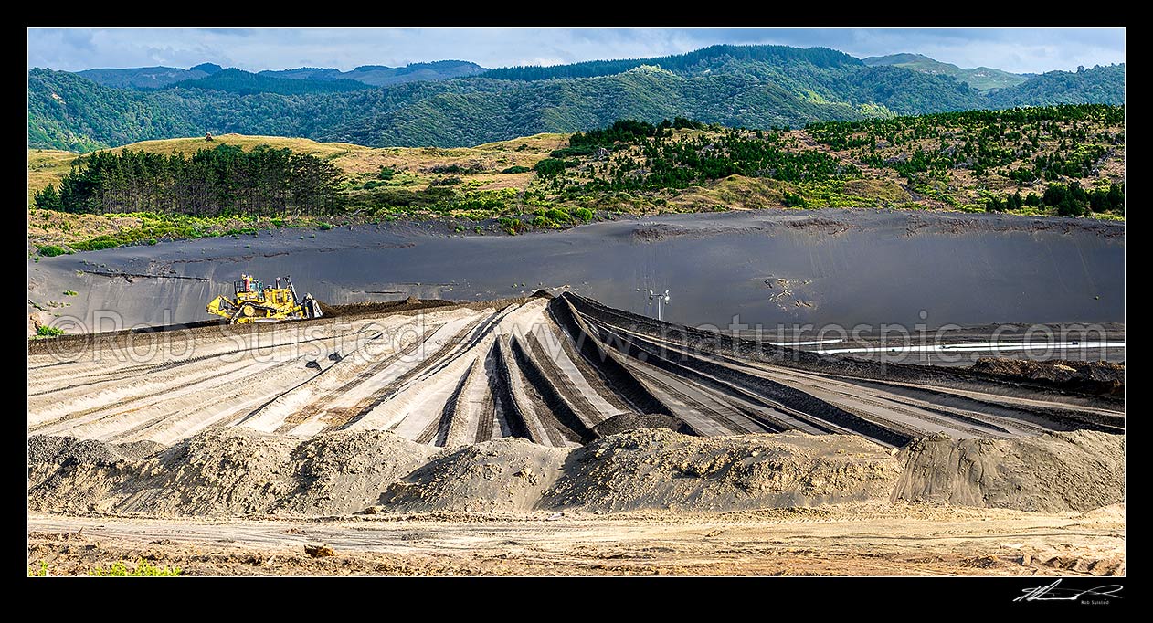 Image of Taharoa Ironsands mining operation owned by NZ Steel. Bulldozer pushing iron rich sand. Panorama, Taharoa, Waitomo District, Waikato Region, New Zealand (NZ) stock photo image