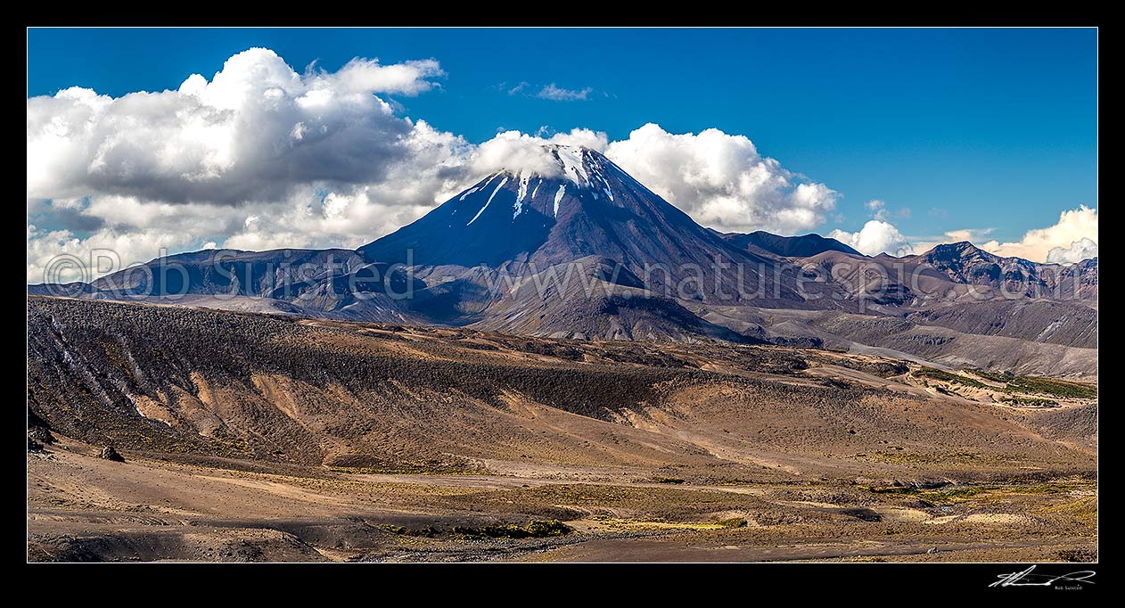 Image of Mt Ngauruhoe (2287m) standing above the dry barren volcanic landscape of the Rangipo Desert and Mangatoetoenui stream. Panorama, Tongariro National Park, Taupo District, Waikato Region, New Zealand (NZ) stock photo image