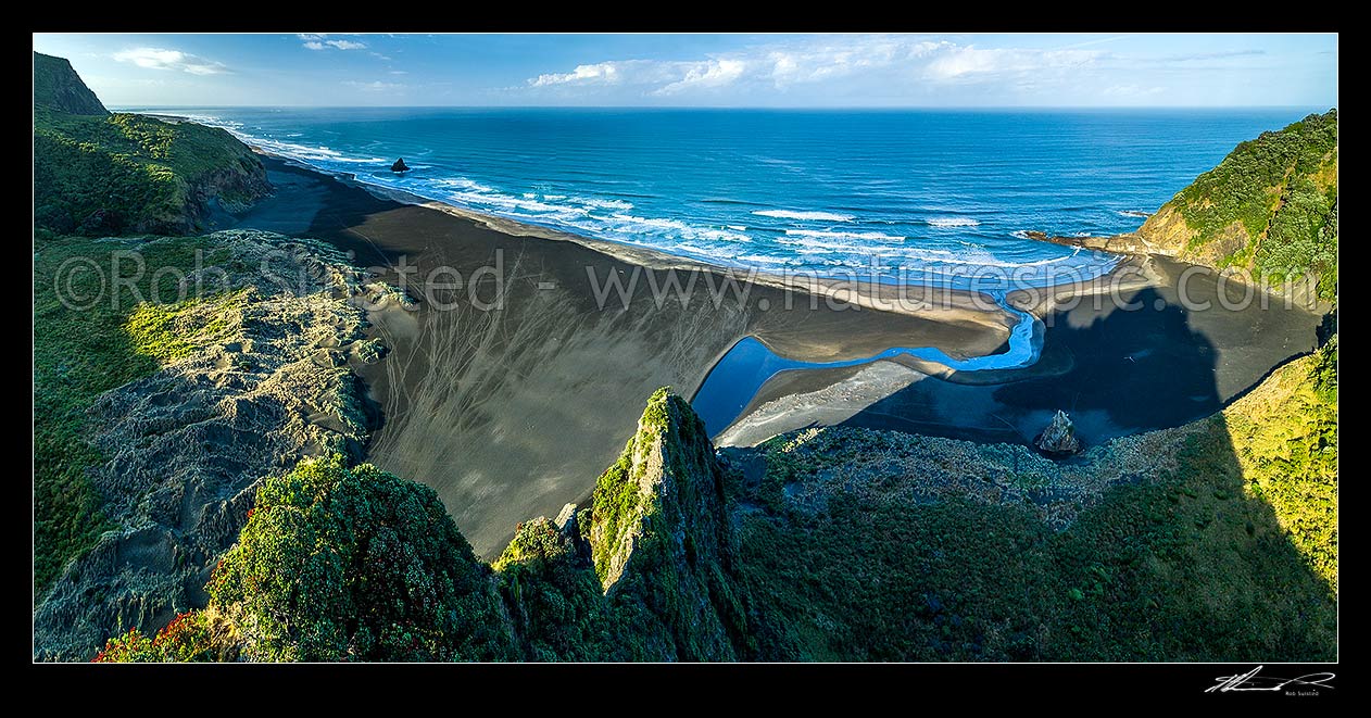 Image of Karekare Beach, Karekare Stream and Union Bay, seen from above The Watchman. Panatahi Island at left, Farley Point at right. Aerial panorama, Karekare Beach, Waitakere City District, Auckland Region, New Zealand (NZ) stock photo image