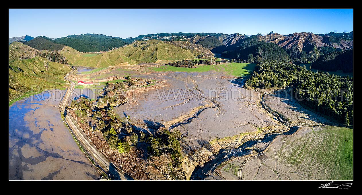 Image of Tolaga Bay floods in June 2018 brought large amounts of forestry timber slash and topsoil down Tapuwae Stream to inundate farmland on Paroa Road. Aerial panorama. Note forestry slash foregound, Tolaga Bay, Gisborne District, Gisborne Region, New Zealand (NZ) stock photo image