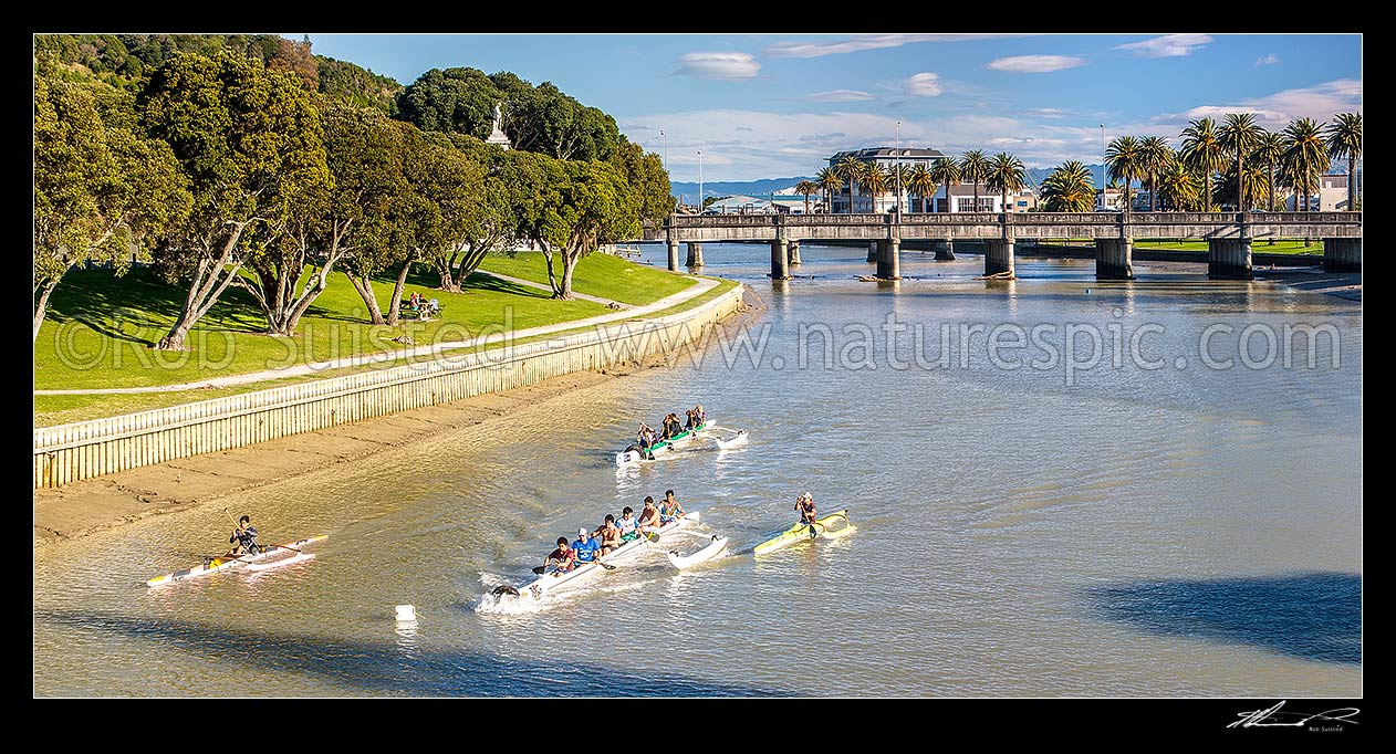 Image of Gisborne City and Turanganui River, with young people practicing Waka Ama outrigger canoe racing near the Gladstone Road Bridge. Panorama, Gisborne City, Gisborne District, Gisborne Region, New Zealand (NZ) stock photo image