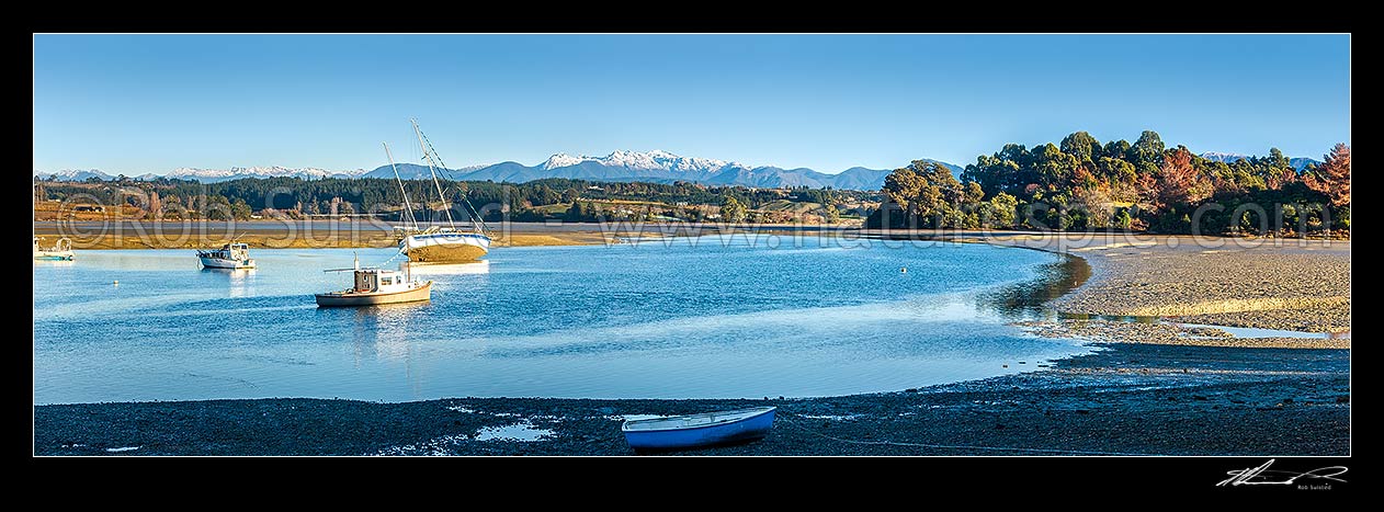 Image of Waimea Inlet at low tide with boats on moorings at Mapua. Kahurangi National Park and Arthur Range beyond. Panorama, Mapua, Tasman District, Tasman Region, New Zealand (NZ) stock photo image