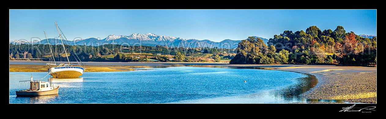 Image of Waimea Inlet at low tide with boats on moorings at Mapua. Kahurangi National Park and Arthur Range beyond. Panorama, Mapua, Tasman District, Tasman Region, New Zealand (NZ) stock photo image