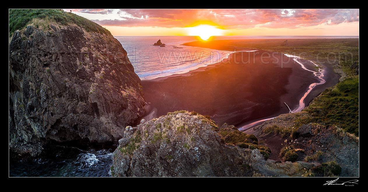 Image of Whatipu Beach sunset beyond Paratutae Island (left) and Ninepin Rock. Burnett Head centre. Aerial panorama, Whatipu Beach, Waitakere City District, Auckland Region, New Zealand (NZ) stock photo image