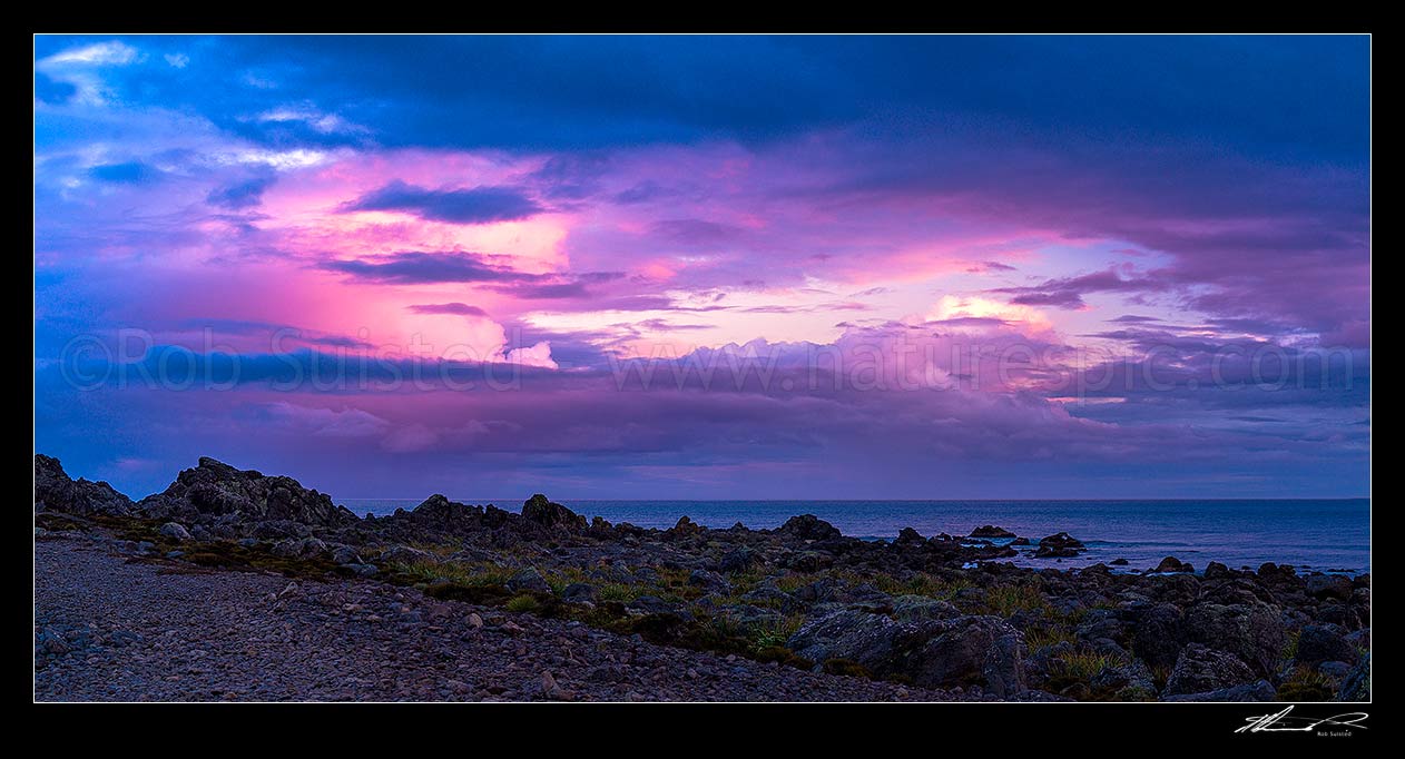 Image of Turakirae Head Scientific Reserve with twilight coloured sky above at sunset. Cook Strait beyond. Panorama, Turakirae Head, Hutt City District, Wellington Region, New Zealand (NZ) stock photo image