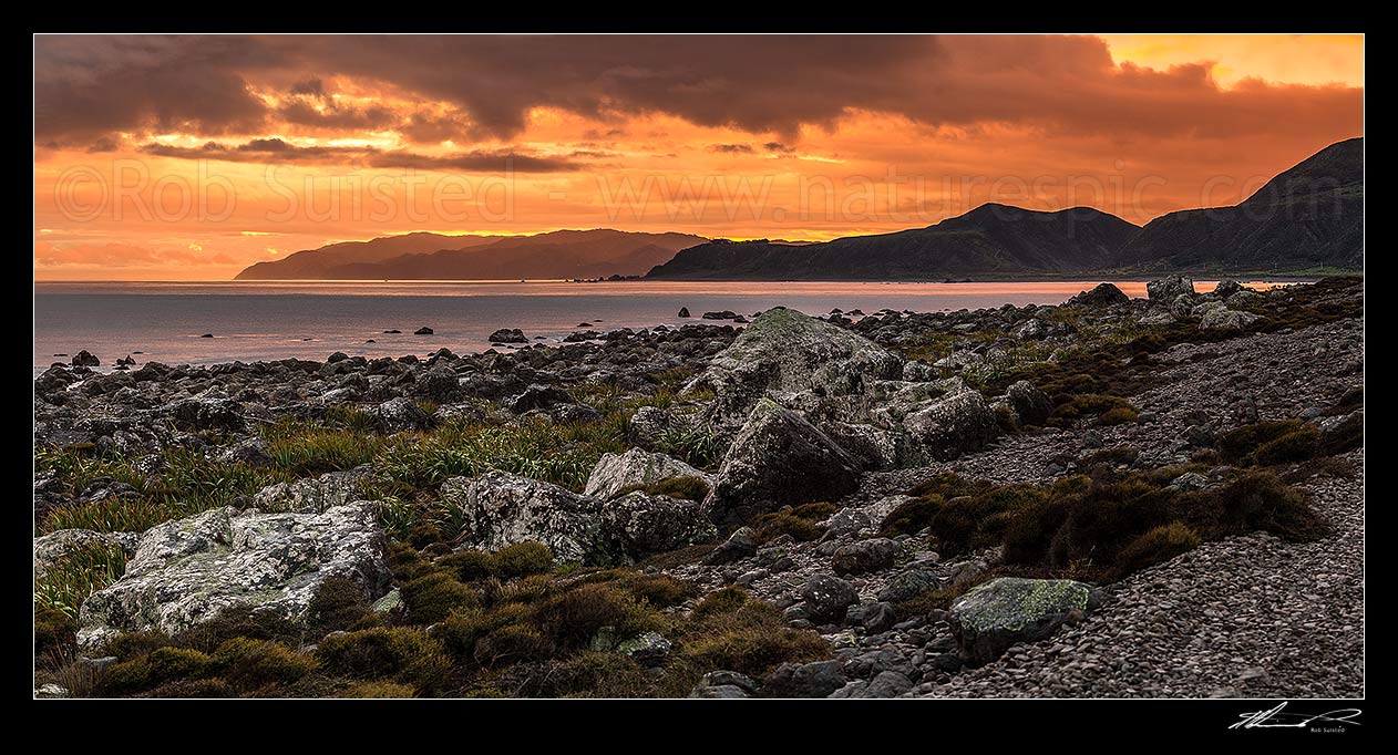 Image of Turakirae Head sunset, looking back towards Wellington at dusk. Baring Head centre, with Sinclair Head beyond. Cook Strait at left. Turakirae Head Scientific Reserve. Panorama, Turakirae Head, Hutt City District, Wellington Region, New Zealand (NZ) stock photo image