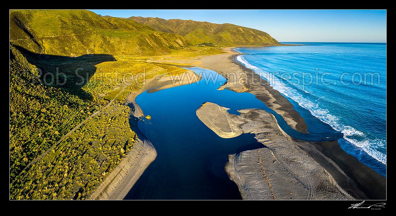 Image of Wainuiomata River mouth entering sea near Baring Head, forming a coastal tidal lake in beach gravels. Aerial panorama with Turakirae Head and Orongorongo Valley behind, Baring Head, Hutt City District, Wellington Region, New Zealand (NZ) stock photo image