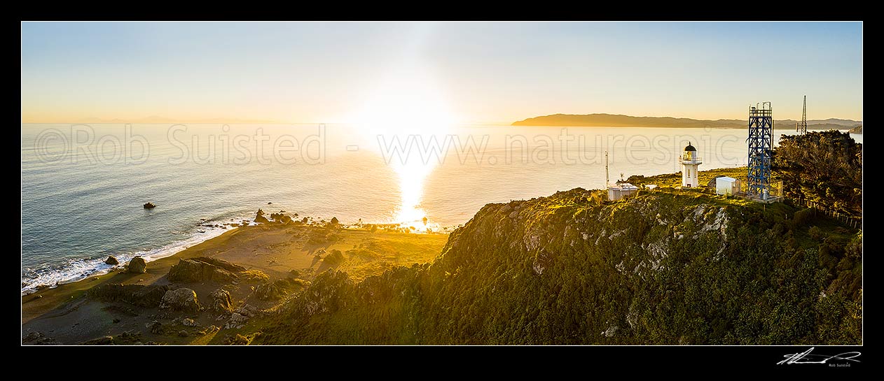 Image of Baring Head and East Harbour Regional Park at sunset, looking past lighthouse complex, Wellington Harbour entrance to Sinclair Head beyond. Aerial panorama, Baring Head, Hutt City District, Wellington Region, New Zealand (NZ) stock photo image