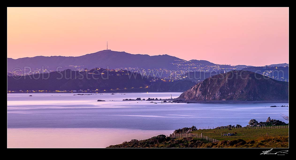 Image of Wellington City and Wellington Harbour entrance, seen from Baring Head East Harbour Regional Park. Pencarrow Head lighthouses right, Mt Kaukau above. Evening panorama, Baring Head, Hutt City District, Wellington Region, New Zealand (NZ) stock photo image