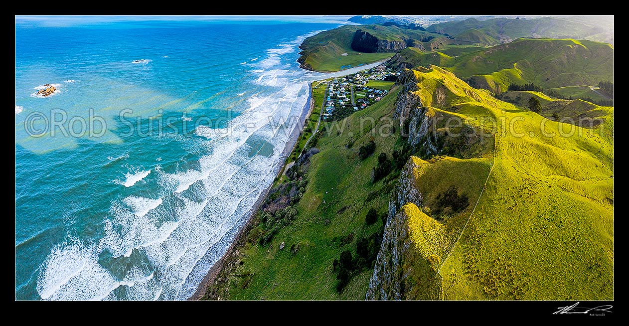 Image of Kairakau Beach village nestled under coastal escarpment cliffs, on the Mangakuri River mouth. Aerial panorama looking south, Kairakau Beach, Hawke's Bay Region, New Zealand (NZ) stock photo image