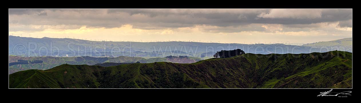 Image of Farmland view over northern Wairarapa towards the ridgeline wind turbines of Tararua Wind farm, over looking Pahiatua to Mangatainoka area. Panorama view, Pori, Tararua District, Manawatu-Wanganui Region, New Zealand (NZ) stock photo image