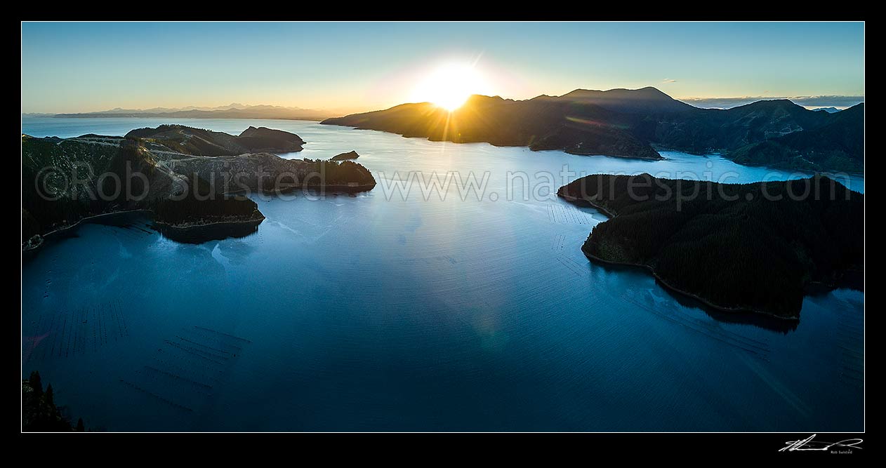 Image of Port Underwood, Marlborough Sounds, with sunset over the Robertson Range. Kaikoura Ranges and Cloudy Bay left, Separation point right. Aerial panorama, Port Underwood, Marlborough District, Marlborough Region, New Zealand (NZ) stock photo image