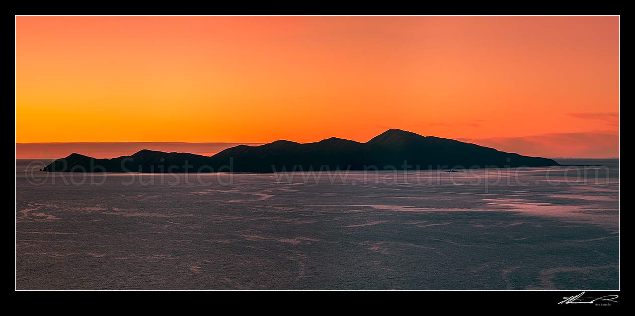 Image of Kapiti Island sunset panorama. Mt Taranaki visible left of Kapiti, Paraparaumu, Kapiti Coast District, Wellington Region, New Zealand (NZ) stock photo image