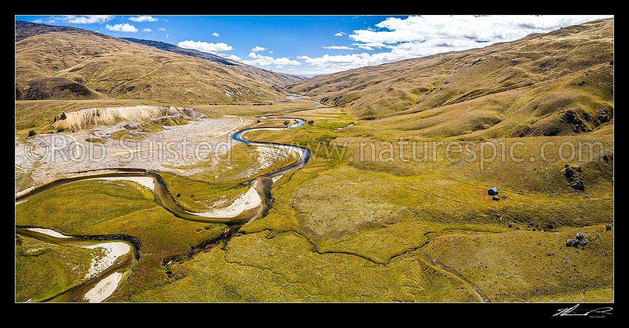 Image of Nevis River valley near Whittens Stream looking north. Historic gold mining sluicings at left, old musterers hut at right. Garvie Mountains at right. Aerial panorama, Nevis, Central Otago District, Otago Region, New Zealand (NZ) stock photo image