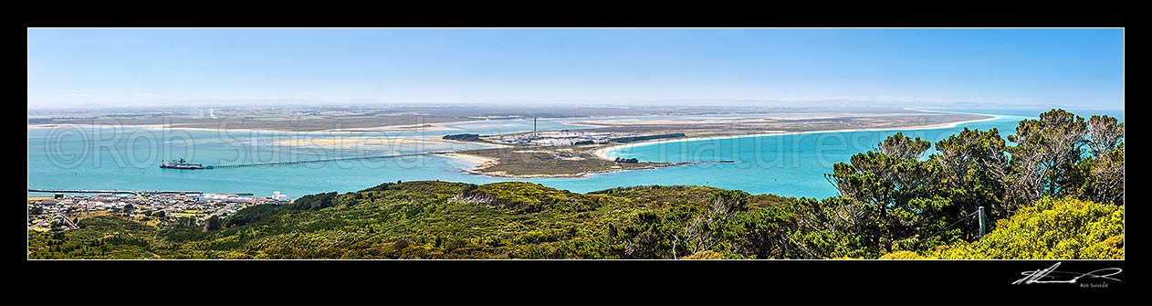 Image of Tiwai Point aluminium smelter, with bulk carrier ship Africa Bulker unloading Bauxite to Tiwai Point aluminium smelter via Tiwai Wharf. Toetoes Bay far right. Panorama, Bluff, Invercargill District, Southland Region, New Zealand (NZ) stock photo image