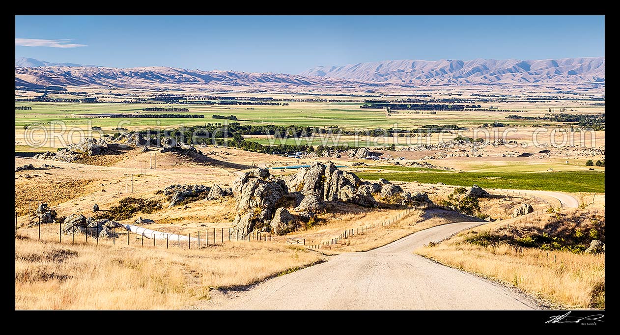 Image of Upper Taieri Plain seen from near Paerau. Panorama over irrigated plains of the Upper Taieri towards the Hawkdun and Ida Ranges, and Rough Ridge (left). Maniototo, Patearoa, Central Otago District, Otago Region, New Zealand (NZ) stock photo image