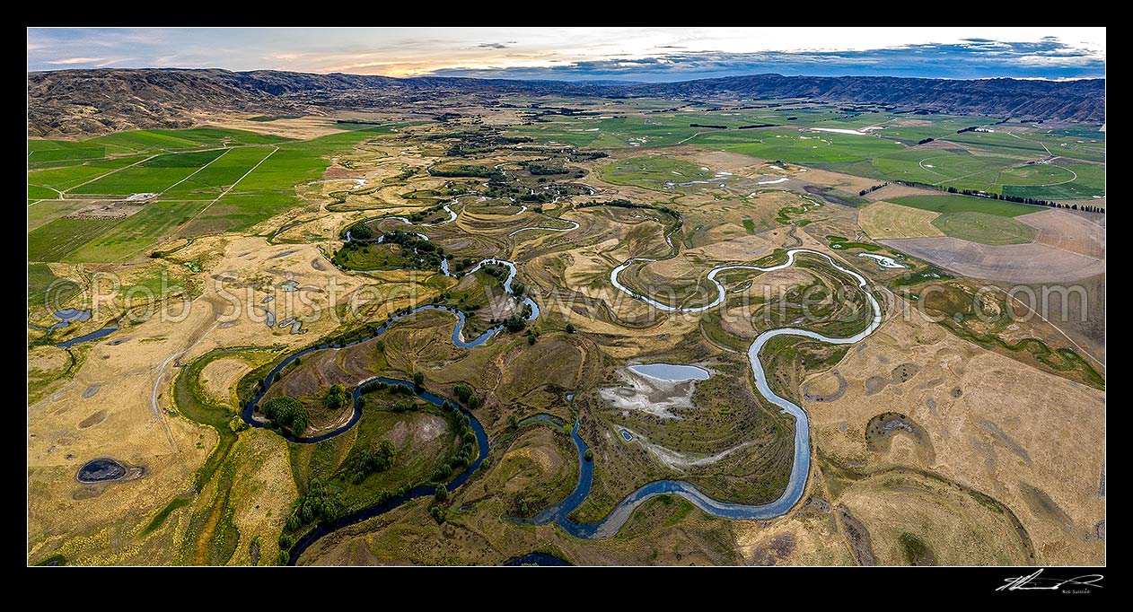 Image of Upper Taieri Plain River Scroll Plain Patearoa, looking south and upstream past irrigated dairy farming pasture and pivot irrigators, towards Paerau Styx. Maniototo. Aerial panorama, Patearoa, Central Otago District, Otago Region, New Zealand (NZ) stock photo image