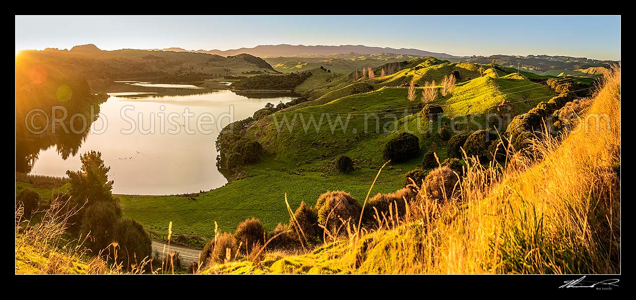 Image of Lake Rotonuiaha, nestled in northern Hawkes Bay farmland. Golden autumn colours and poplar trees at golden dusk. Panorama, Mohaka, Wairoa District, Hawke's Bay Region, New Zealand (NZ) stock photo image